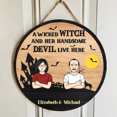 A Wicked Witch And Her Handsome Devil Live Here - Couple Personalized Custom Round Shaped Home Decor Witch Wood Sign - Halloween Gift For Witches, Husband Wife - OLESA