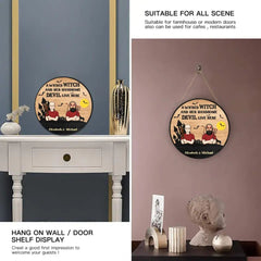 A Wicked Witch And Her Handsome Devil Live Here - Couple Personalized Custom Round Shaped Home Decor Witch Wood Sign - Halloween Gift For Witches, Husband Wife - OLESA